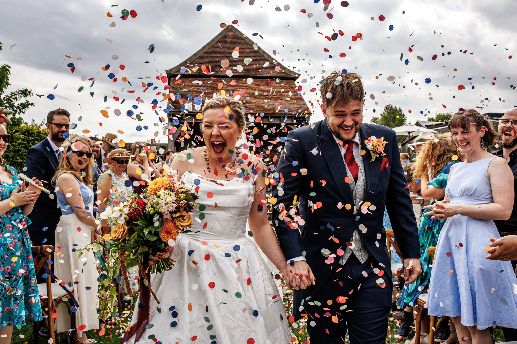 barns at redcoats wedding n&d hertfordshire wedding photographer rafe abrook photography-1076 Bride & Groom walking down an aisle of confetti at the barns at redcoats near Hitchin